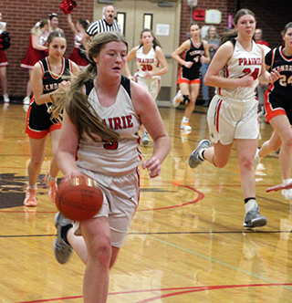 Hailey Hanson brings the ball upcourt against Kendrick. Also shown is Kylie Schumacher with Reagan Brannan in the background.