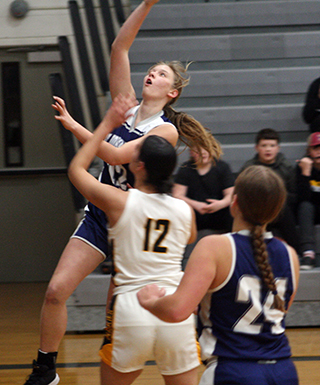 Julia Wassmuth goes for a lay-up as Sarah Waters watches.