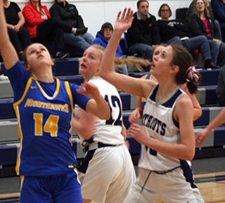 Catherine Beckman and Madeline Wassmuth go for a rebound in their game against Nezperce. Photo by Steve Wherry.