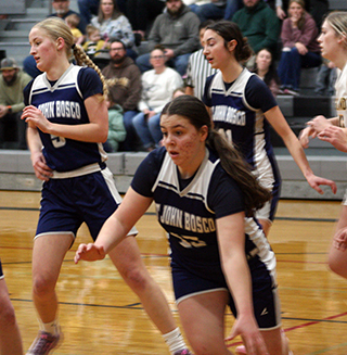 Cece Remacle handles the ball during St. John Bosco’s District game at Highland. Also shown are Catherine Seubert and Savannah Perrin. Photo by Steve Wherry.