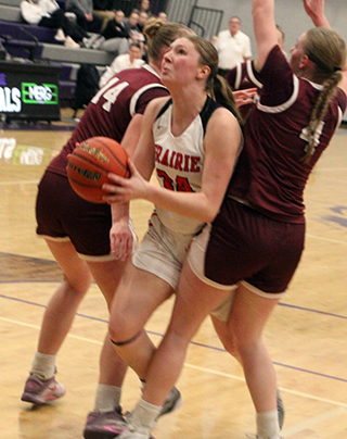 Kylie Schumacher found the going tough against Kamiah at District as she tries to push between two players for a shot.