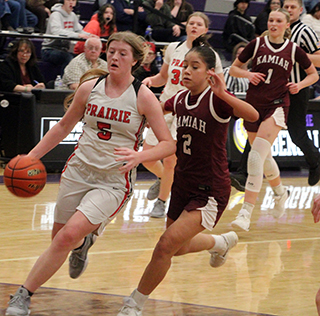 Hailey Hanson drives toward the hoop against Kamiah at District. Also shown is Sage Elven.