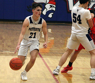Cody Weckman handles the ball as Connor Nuxoll sets a pick in the state play-in game against Greenleaf.