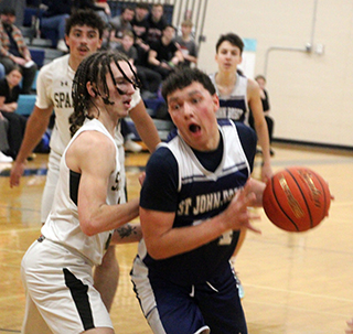Connor Nuxoll looks to make a play against Timberline in the District Championship game. Also shown is Joseph Waters.