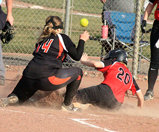 Halee Rowland slides into home with a run against Pomeroy.