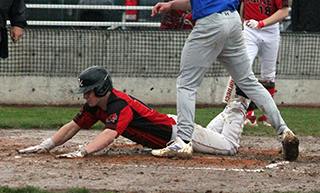 Chris Schumacher scores on a head first slide for Prairie's first run at Genesee.