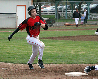 Levi McElroy hustles to first for an infield single at Kendrick.