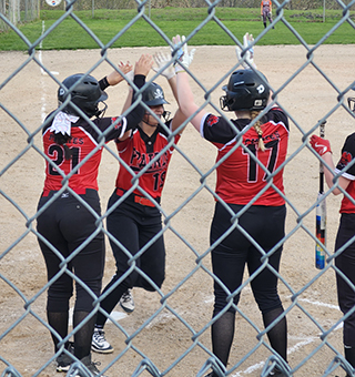 Kenly Forsmann is greeted at home plate by Audrey Warren and Bailey Key after her 3-run homer at Kendrick. Photo by Stephanie Forsmann.