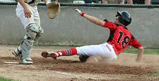 Kade Quintal slides into home with a run against Potlatch.