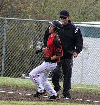 Levi McElroy rounds first after hitting a single against C.V.