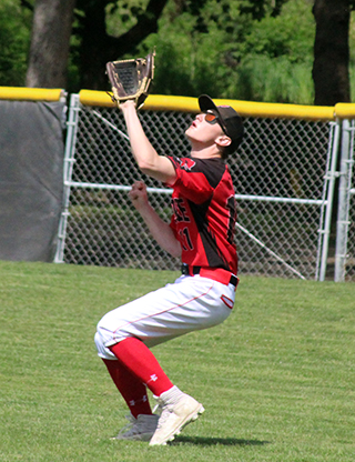 Max Rehder battles the sun as he gets ready to make a catch against Kendrick at District.