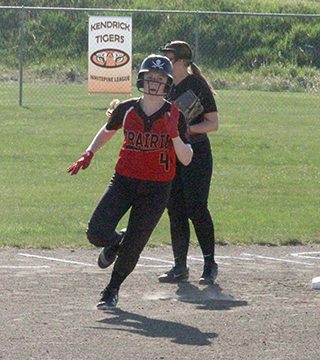 Erica Schlader with the first of two triples in their home finale against Kendrick.