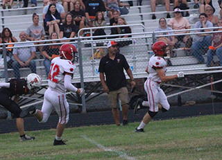 Cooper Riener races down the sidelines for the first touchdown of the game at Troy. Trailing is Sam Rehder.