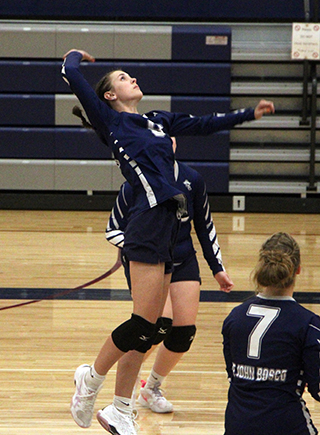 Catherine Beckman goes for a spike against Highland.