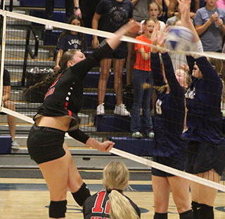 Kylie Schumacher came alive at the net in the final 3 games at Logos helping Prairie rally from a 0-2 deficit to win in 5. Also shown is Avery Riener.