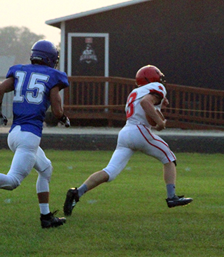 Freshman Cooper Riener had a big game as a receiver for the Pirates. On this play he is headed for the end zone on a 20-yard pass play.