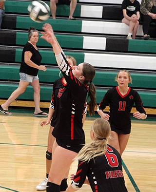 Kylie Schumacher sends the ball over the net at Potlatch. Also shown are Avery Riener, Kennedy Riener, 11, and Mia Anderson, 6.