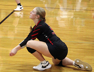Erica Schlader digs a CV serve.