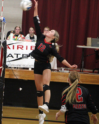 Avery Riener goes up for a spike against Lapwai. Also shown is Kylee Riggers.
