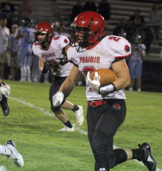 Levi Gehring gets around left end on his way to a 53 yard scoring run. Also shown is Kade Quintal.