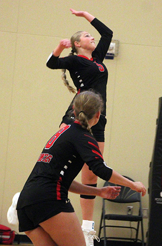 Beka Schumacher goes up for a spike at Spokane. Also shown is Halee Rowland.