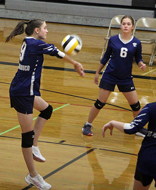 Catherine Beckman makes a pass as Maggie Black looks on in the St. John Bosco match at Highland last week.