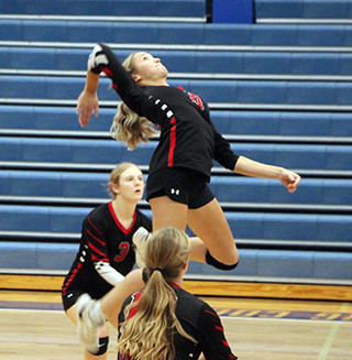 Kennedy Riener winds up for a spike at the Pea & Lentil Tournament at Genesee. Also shown are Erica Schlader and Bekah Shears.