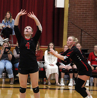 Faith Cash sets the ball while Mia Anderson gets ready in case the set comes her way in the match against Potlatch.