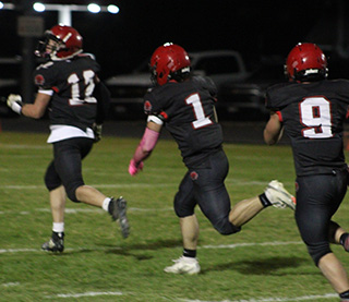 Lane Mader, 1, carries the ball after picking up a Potlatch fumble. He went 80 yards for a touchdown. Leading the way is Sam Rehder with Ashton Martin following.