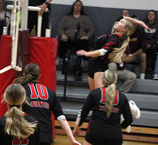 Avery Riener goes up for a spike at Kamiah.