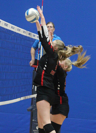 Beka Schumacher makes a block against Kamiah at District. Also  going for the block is Mia Anderson.