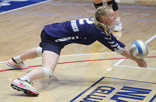 Madeline Wassmuth dives to dig a serve against Nezperce at District.