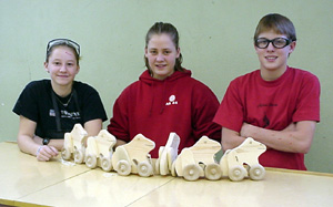 Diana Wadleigh, Charlene Duman and Jake Holthaus with pull-frogs they built for preschoolers.