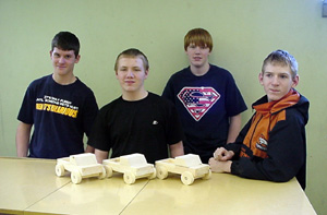 Keith Schultz, Cody Taylor, Ben Forsmann and Jared Nau with pickups they built for the preschoolers.