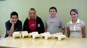 Richard Sonnen, Deziree Strang, Justin Stubbers and Nicole Nida with the pickups they built for preschoolers.