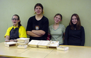 Shandrie Poxleitner, J.D. Riener, Nicole Lettenmaier and Deanne Reed with the tic-tac-toe games they built for preschoolers.