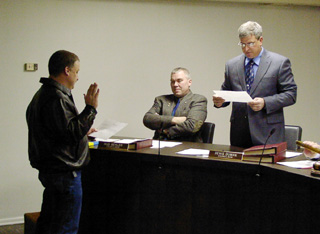 Jack Duman is sworn in as a city councilman by new mayor Denis Duman.