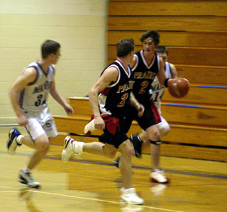 Tyler Crane takes the ball upcourt after a steal at Orofino. Jacob Riener runs with him.