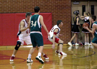 Chad Arnzen and Matt Baerlocher play defense against Potlatch.