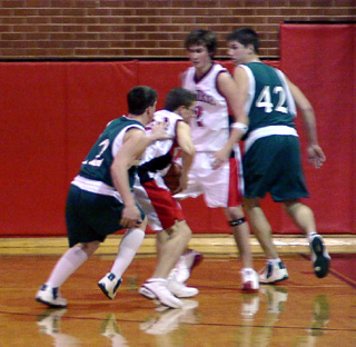 Jacob Riener has just come up with a steal against Potlatch as Tyler Crane watches.