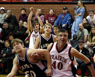 Chad Arnzen battles for rebounding position after Tyler Crane, background, launches a 3-point try.