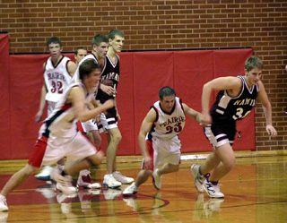 Tyler Crane and Shane Doyle race a Kamiah player to a ball that Doyle had knocked loose.