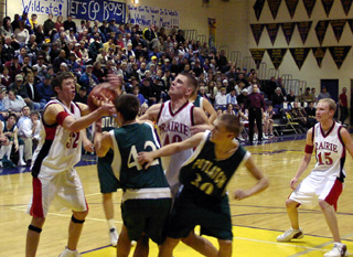It's a battle for a loose ball between Matt Baerlocher and Chad Arnzen and several Potlatch players. At right is Brent Frei.