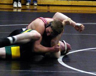 Logan Lustig is getting close to winning by pin in the match that clinched a state berth.