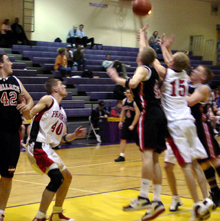 Brent Frei goes after a long rebound off a missed free throw. At left is Chad Arnzen.
