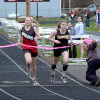 Bridget Enneking edges past a Timberline runner to win the 800.