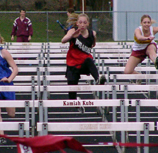 Tabitha Sonnen clears a hurdle on her way to winning the 100 meter event.