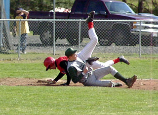 Jacob Riener wipes out the third baseman on a steal attempt.