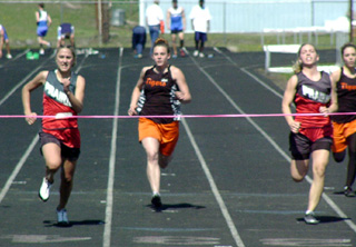 Nicole Nida, left, edges teammate Vanessa Sonnen in the 100 as they finished 1-2.