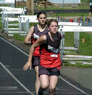 Allison Jones passes the baton to Kayla Uhlenkott in the 4x200 relay.